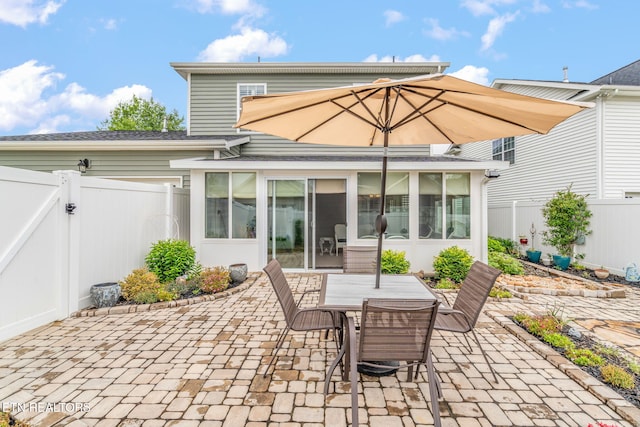 128 Hackberry St, Oak Ridge, TN 37830 - fenced backyard featuring a patio area, a sunroom, a gate, and outdoor dining area