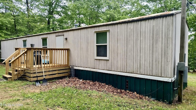 489 Trimmer Ln, Jamestown, TN 38556 - rear view of house with a deck and view of wooded area