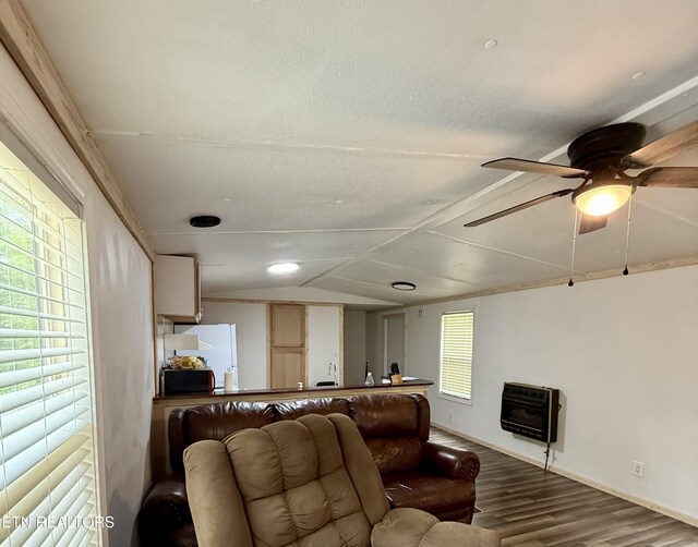 489 Trimmer Ln, Jamestown, TN 38556 - living area with wood finished floors, heating unit, a ceiling fan, lofted ceiling, and baseboards