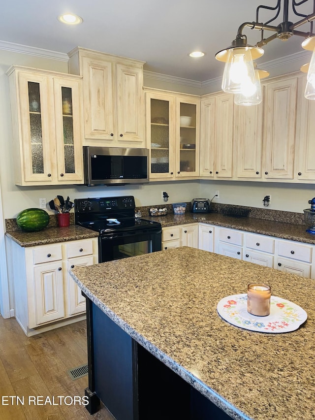 318 Deer Trail Dr, Dandridge, TN 37725 - kitchen with black / electric stove, stainless steel microwave, wood finished floors, crown molding, and dark stone counters