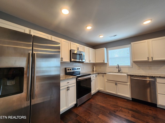 7928 Poplar Grove Ln, Powell, TN 37849 - kitchen featuring stainless steel appliances, a sink, light stone counters, decorative backsplash, and recessed lighting