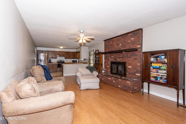 1502 Woodbury Ct, Maryville, TN 37803 - living area with light wood-style floors, ceiling fan, a fireplace, and a textured ceiling