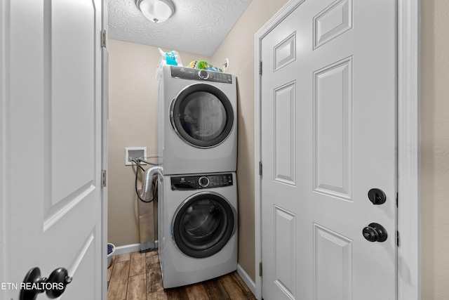 2055 Scott St, Sevierville, TN 37876 - washroom featuring stacked washer / drying machine, baseboards, wood finished floors, and a textured ceiling