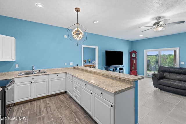 2055 Scott St, Sevierville, TN 37876 - kitchen with a sink, open floor plan, ceiling fan, electric range, and white cabinetry