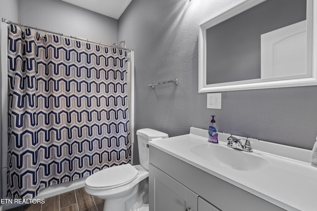 2055 Scott St, Sevierville, TN 37876 - bathroom featuring toilet, vanity, a textured wall, curtained shower, and wood finished floors