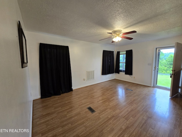 288 Machine Branch Rd, Ewing, VA 24248 - spare room featuring a textured ceiling, wood finished floors, ceiling fan, and baseboards
