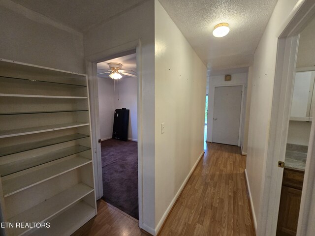 288 Machine Branch Rd, Ewing, VA 24248 - hallway with wood finished floors, baseboards, and a textured ceiling