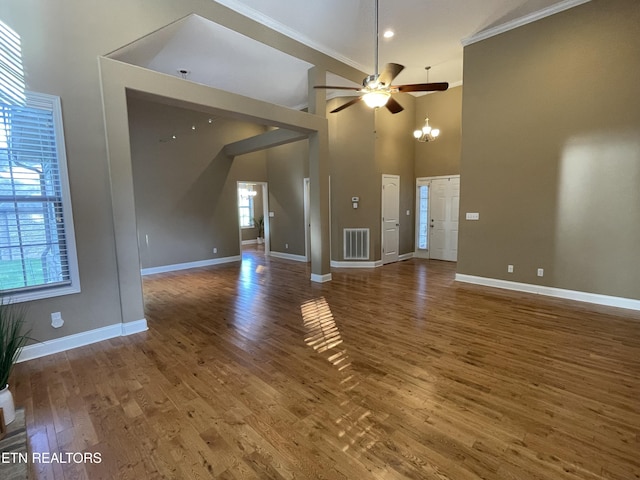 103 Crossroads Blvd, Oak Ridge, TN 37830 - unfurnished living room featuring ornamental molding, ceiling fan, baseboards, wood finished floors, and a towering ceiling
