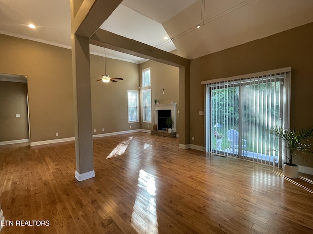 103 Crossroads Blvd, Oak Ridge, TN 37830 - unfurnished living room featuring high vaulted ceiling, baseboards, wood finished floors, ceiling fan, and crown molding