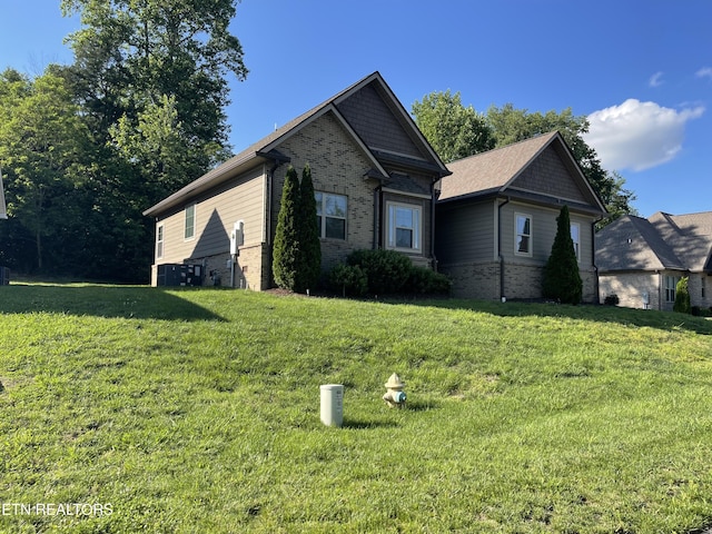 103 Crossroads Blvd, Oak Ridge, TN 37830 - view of property exterior with brick siding, a yard, and central AC unit