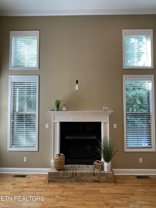 103 Crossroads Blvd, Oak Ridge, TN 37830 - living area featuring wood finished floors, crown molding, baseboards, a fireplace, and plenty of natural light