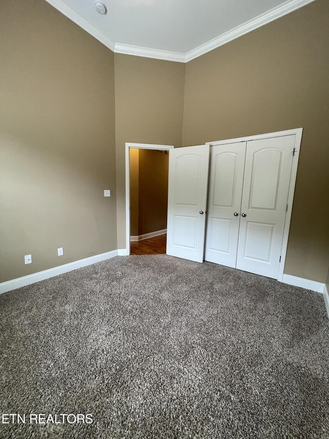 103 Crossroads Blvd, Oak Ridge, TN 37830 - unfurnished bedroom with ornamental molding, baseboards, carpet floors, and a closet