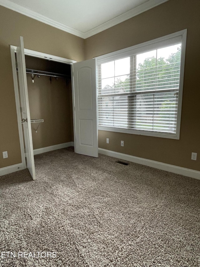 103 Crossroads Blvd, Oak Ridge, TN 37830 - unfurnished bedroom featuring crown molding, baseboards, a closet, multiple windows, and carpet flooring
