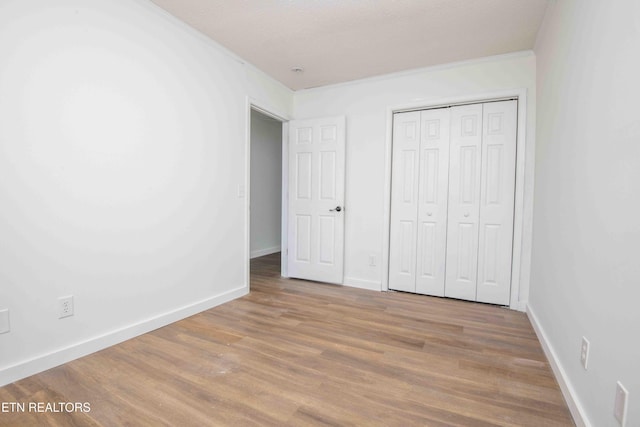 1713 Sails Way, Knoxville, TN 37932 - unfurnished bedroom with wood finished floors, baseboards, and a closet