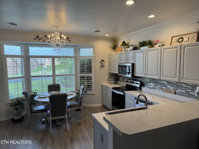 740 Sterchi Park Way Unit F7, Knoxville, TN 37912 - kitchen with appliances with stainless steel finishes, a chandelier, dark wood-type flooring, backsplash, and baseboards