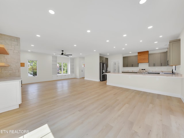 7747 Drawbridge Ct, Powell, TN 37849 - unfurnished living room with a ceiling fan, recessed lighting, light wood-style floors, baseboards, and a sink