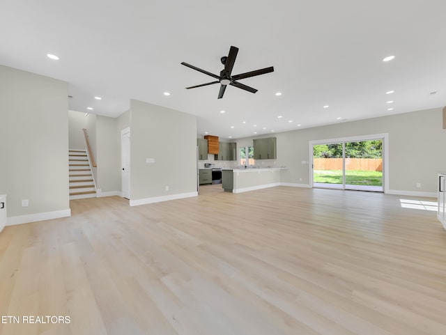 7747 Drawbridge Ct, Powell, TN 37849 - unfurnished living room with a ceiling fan, light wood-type flooring, recessed lighting, stairs, and baseboards
