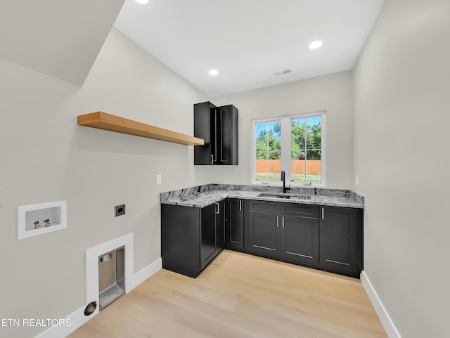 7747 Drawbridge Ct, Powell, TN 37849 - laundry room with light wood-style flooring, baseboards, hookup for an electric dryer, cabinet space, and washer hookup