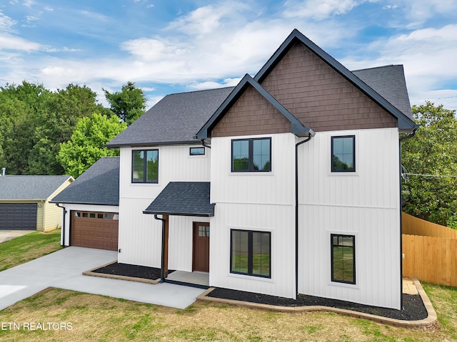7747 Drawbridge Ct, Powell, TN 37849 - modern inspired farmhouse with a shingled roof, a garage, and concrete driveway