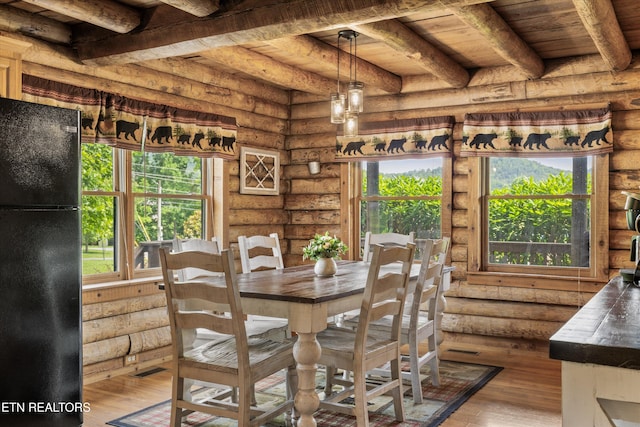 3509 Ginseng Way, Sevierville, TN 37862 - dining room with log walls, wood-type flooring, healthy amount of natural light, and wooden ceiling with exposed beams