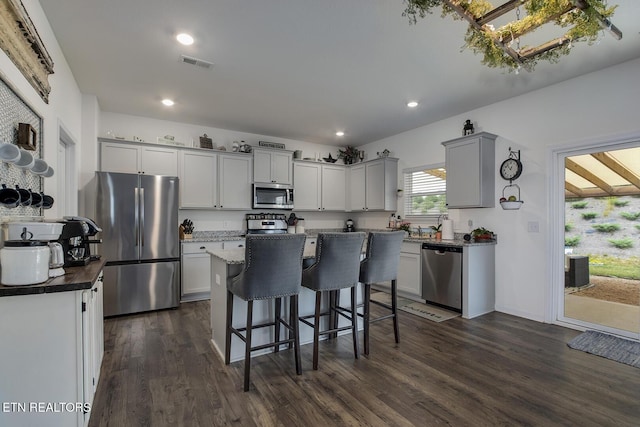 12017 Spearmint Ln, Knoxville, TN 37932 - kitchen with stainless steel appliances, a breakfast bar, dark wood-style floors, a center island, and recessed lighting