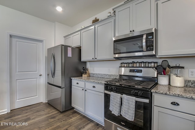 12017 Spearmint Ln, Knoxville, TN 37932 - kitchen featuring appliances with stainless steel finishes, dark wood-style floors, and light stone counters