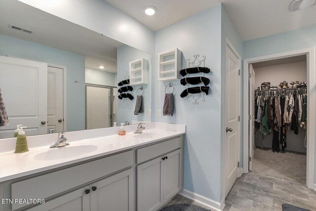 12017 Spearmint Ln, Knoxville, TN 37932 - full bath featuring a spacious closet, double vanity, a shower stall, and baseboards