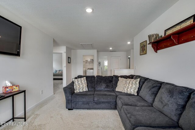 12017 Spearmint Ln, Knoxville, TN 37932 - carpeted living area featuring attic access, washing machine and clothes dryer, recessed lighting, and baseboards