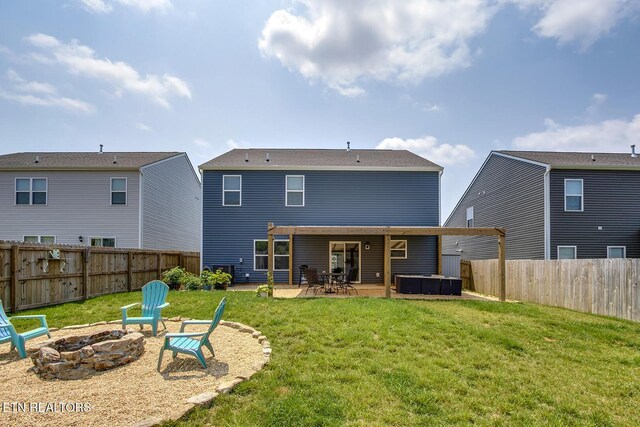 12017 Spearmint Ln, Knoxville, TN 37932 - rear view of property with a hot tub, a fire pit, and a patio area