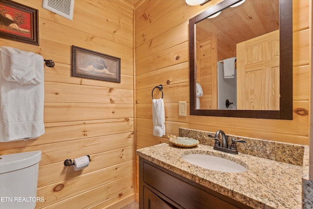 2377 Alpine Village Way, Pigeon Forge, TN 37862 - bathroom with vanity, wooden walls, and toilet