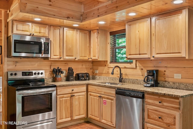 2377 Alpine Village Way, Pigeon Forge, TN 37862 - kitchen featuring stainless steel appliances, light brown cabinetry, a sink, light stone counters, and light wood-style flooring