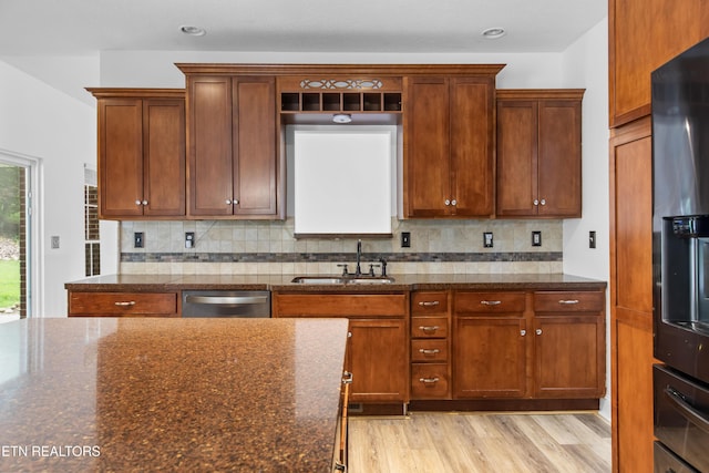 128 Harbour View Way, Kingston, TN 37763 - kitchen with a sink, dishwasher, dark stone countertops, light wood-style floors, and decorative backsplash