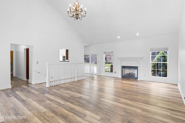 128 Harbour View Way, Kingston, TN 37763 - unfurnished living room featuring high vaulted ceiling, a chandelier, light wood-type flooring, baseboards, and recessed lighting