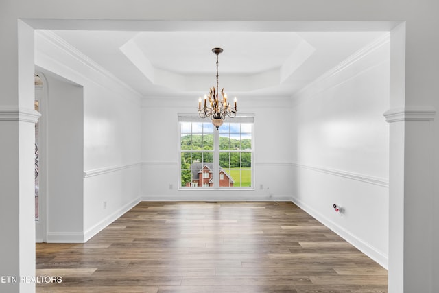 128 Harbour View Way, Kingston, TN 37763 - unfurnished dining area featuring a chandelier, a raised ceiling, wood finished floors, baseboards, and ornamental molding
