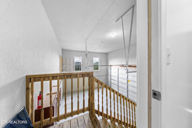 128 Harbour View Way, Kingston, TN 37763 - hallway with a textured wall, wood finished floors, and an upstairs landing