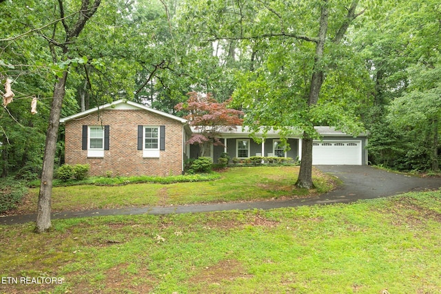 106 Morgan Rd, Oak Ridge, TN 37830 - single story home with driveway, a front yard, a garage, and brick siding