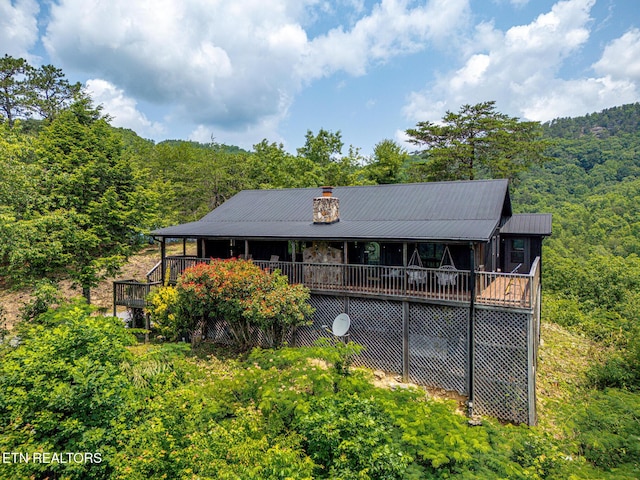3050 Patty View Way, Sevierville, TN 37862 - back of property featuring a wooded view, metal roof, a wooden deck, and a chimney