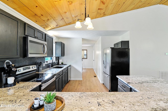 3050 Patty View Way, Sevierville, TN 37862 - kitchen featuring appliances with stainless steel finishes, a sink, light wood-style floors, light stone counters, and a chandelier