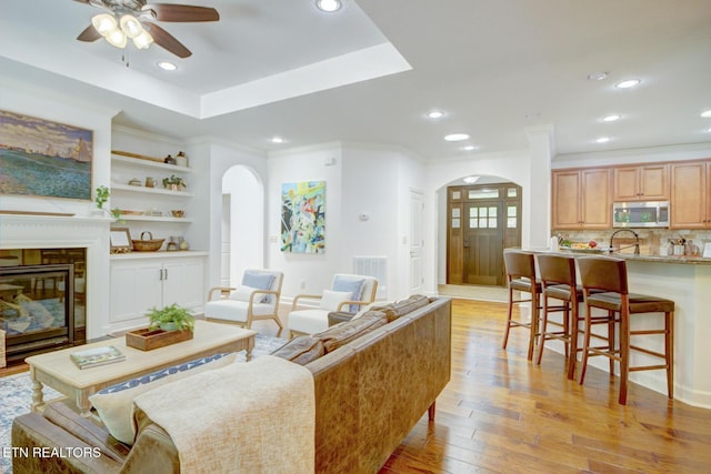 192 Saloli Way, Loudon, TN 37774 - living area featuring arched walkways, ceiling fan, light wood-type flooring, recessed lighting, and a glass covered fireplace