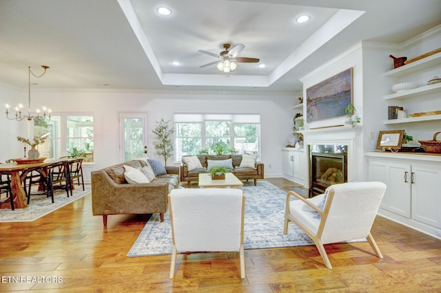 192 Saloli Way, Loudon, TN 37774 - living area with a fireplace with flush hearth, a raised ceiling, light wood-style flooring, ornamental molding, and a ceiling fan
