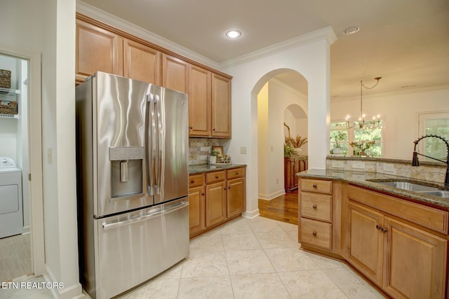 192 Saloli Way, Loudon, TN 37774 - kitchen with stainless steel refrigerator with ice dispenser, washer / dryer, dark stone countertops, ornamental molding, and tasteful backsplash