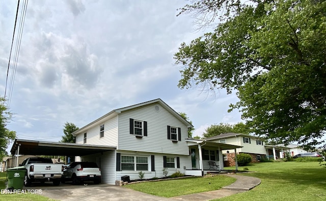 106 Apache Rd, Maryville, TN 37804 - tri-level home with covered porch, a front yard, an attached carport, and driveway