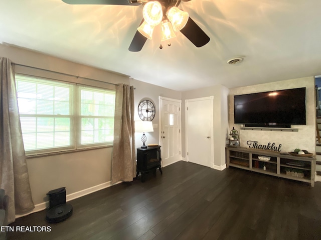 106 Apache Rd, Maryville, TN 37804 - living area with a ceiling fan, baseboards, dark wood-style flooring, and a wood stove