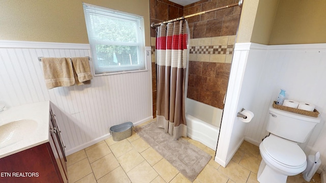 106 Apache Rd, Maryville, TN 37804 - full bathroom featuring vanity, shower / bath combo with shower curtain, a wainscoted wall, toilet, and tile patterned flooring