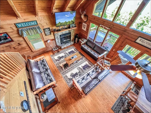2438 Walnut Ridge Way, Sevierville, TN 37862 - living room with wood walls, wood finished floors, and a fireplace