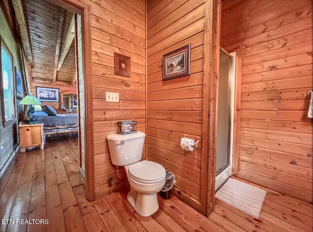 2438 Walnut Ridge Way, Sevierville, TN 37862 - full bath featuring hardwood / wood-style flooring, toilet, wooden walls, and a shower stall