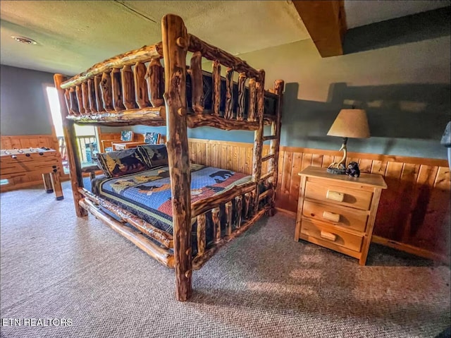 2438 Walnut Ridge Way, Sevierville, TN 37862 - bedroom with a wainscoted wall, carpet flooring, wooden walls, and a textured ceiling