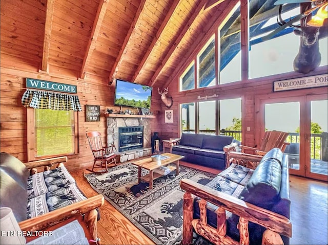 2438 Walnut Ridge Way, Sevierville, TN 37862 - living room with wood finished floors, french doors, wooden walls, high vaulted ceiling, and wooden ceiling with exposed beams