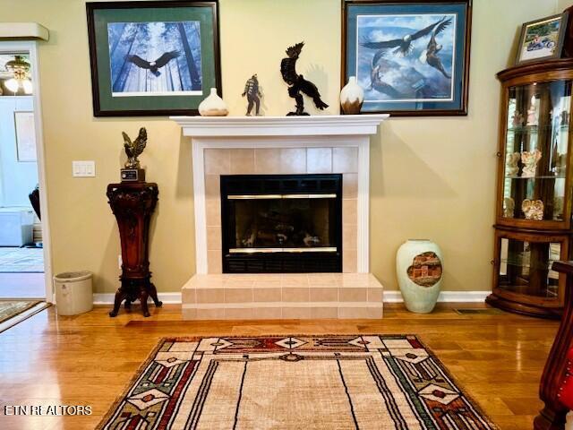 15 Felix Ct, Crossville, TN 38558 - detailed view of wood finished floors, baseboards, and a fireplace