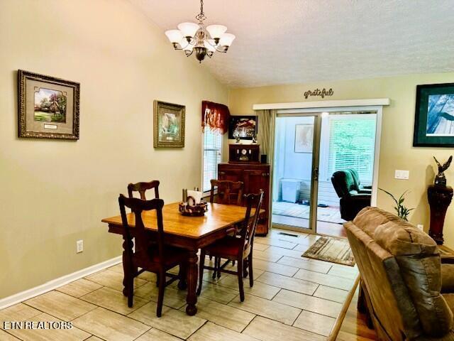 15 Felix Ct, Crossville, TN 38558 - dining room with a chandelier, lofted ceiling, and baseboards